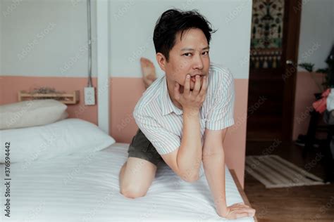 Asian Gay In Stripped Shirt On The Bed With A Weird Posture Like A Cat
