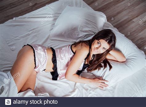 Girl In Pink Pajamas Lying On Bed Stock Photo Alamy