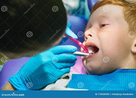 Scared Red Haired Boy Crying At Reception At Dentist In Dental Chair