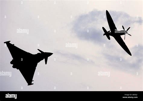 A Eurofighter Typhoon Alongside A Wwii Spitfire In An Aerial Display To