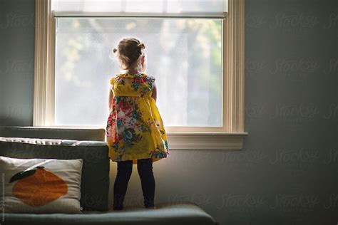 Little Girl Looking Out A Window By Meaghan Curry