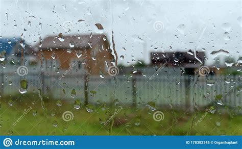 Raindrops Running Down The Glass Of A Country House Window Rain In