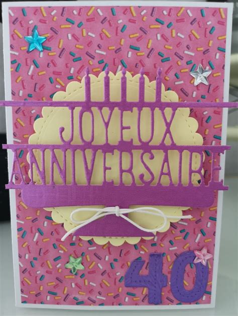 A Handmade Card With The Words Joyeux Anniversary Written In Purple On