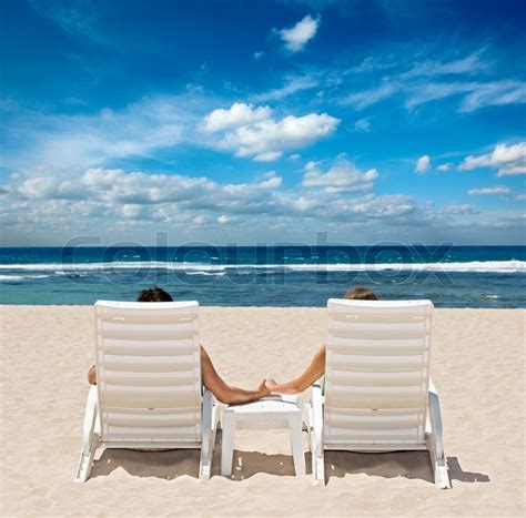 Couple In Beach Chairs Holding Hands Near Ocean Stock Photo Colourbox