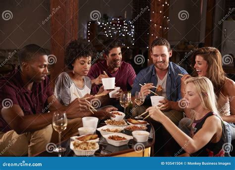 Young Adults Eating Chinese Take Away At A Party At Home Stock Photo