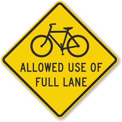 People cycling are protected from motor vehicles by physical barriers such as planters, curbs, or bollards; Allowed Use Of Full Lane Sign - (Bicycle Symbol), SKU: K-6423