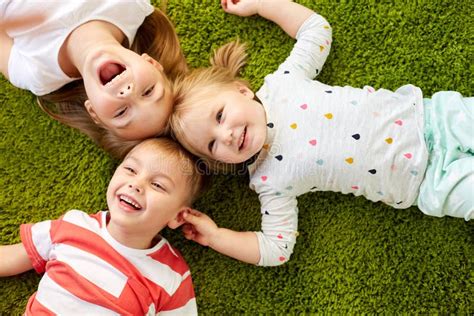 Happy Little Kids Lying On Floor Or Carpet Stock Image Image Of
