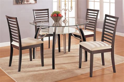 The anderson dining table is a classic design, featuring a beautiful walnut veneer top and standing on sleek steel legs. lean and simple dining table chairs designs