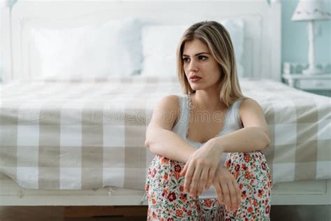 Depressed Young Woman Sitting On Bed At Home Stock Photo Image Of