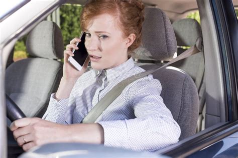 Businesswoman Talking On The Phone While Driving A Car Stock Photo