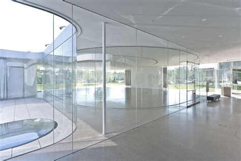 almost invisible sanaa s minimalistic curved glass façades