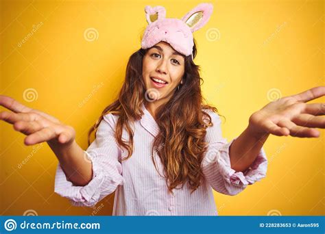 Young Woman Wearing Pajama And Sleep Mask Standing Over Yellow Isolated Background Smiling