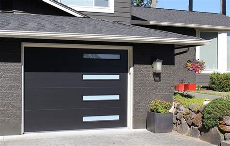 A Black Garage Door In Front Of A House