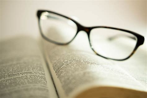 Bokeh Photo Of Reading Glasses Laying On A Page Of An Open Book Creative Commons Bilder