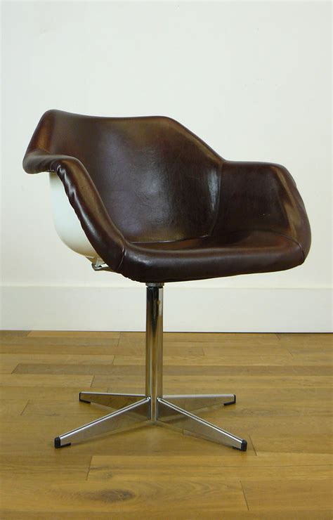 What kind of chair is robin day famous for? Two Robin Day For Hille Swivel Programme Chairs in White