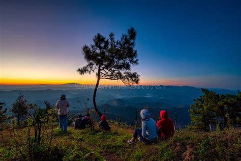 Traveller Looking Sunrise Scene With The Peak Of Mountain And Mist At