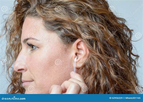 Woman Cleaning Her Ear With A Cotton Swab Stock Image Image Of Buds