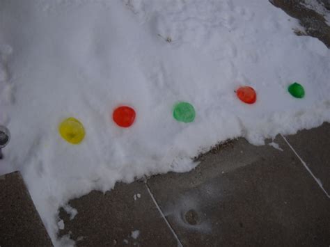 Frozen Water Ballons With Food Coloring Put Out In The Snow And They