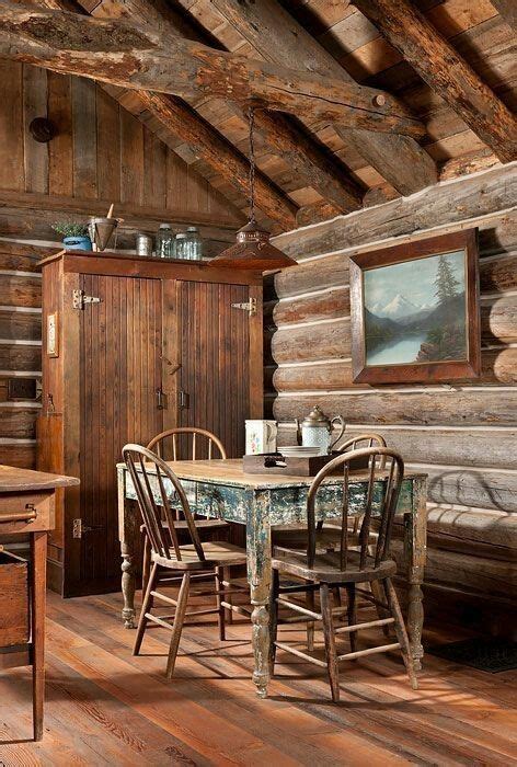 An Old Log Cabin With Wood Floors And Wooden Walls Is Furnished With