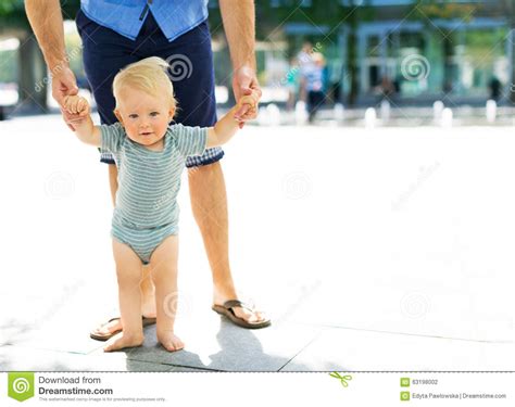 Baby Taking First Steps With Fathers Help Stock Photo Image Of