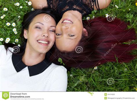 Happy Sisters Lying On Grass Outdoors Stock Image Image Of Mixed Nature 41474223