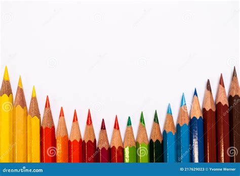 White Background With A Parallel Arrangement Of Colored Pencils Stock