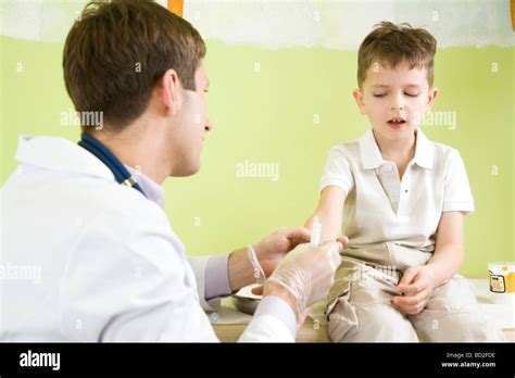 Male Doctor Giving Injection To A Boy Stock Photo Alamy