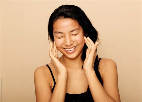 Skincare Moisturiser Stock Photo Happy Asian Woman Smiling Del Colaborador De Stocksy
