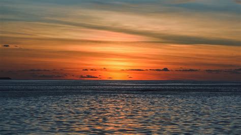 Download Wallpaper 1366x768 Sea Horizon Sunset Clouds Sky Ripples