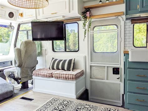 The Inside Of A Camper With Couches Windows And Rugs On The Floor