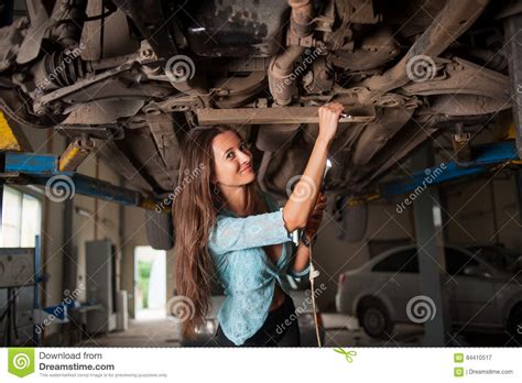 beautiful girl in the auto repair shop stock image image of service examining 84410517