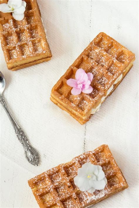 Belgian Waffles Sprinkled With Icing Pink Flowers Stock Image