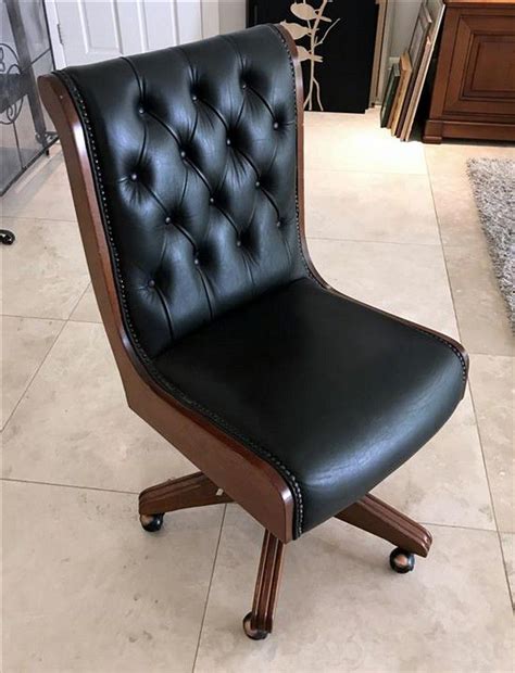 Tufted leather, dark woods, classic/traditional style. A dark green leather upholstered button back office chair ...