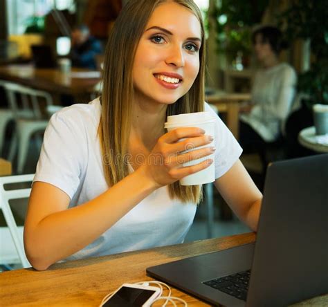 Happy Young Woman Drinking Coffeetea And Using Laptop Stock Image