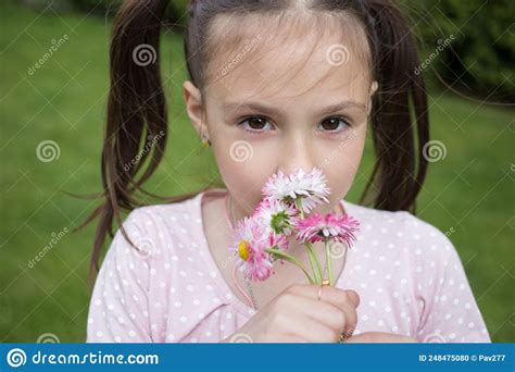 Close Up Portrait Of A Cute Girl 6 7 Years Old With A Small Bouquet Of