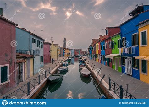 Burano Street With Colorful Houses And Water Channel With Boats