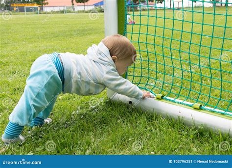 Little Boy Playing On The Football Field With Gates Stock Image Image