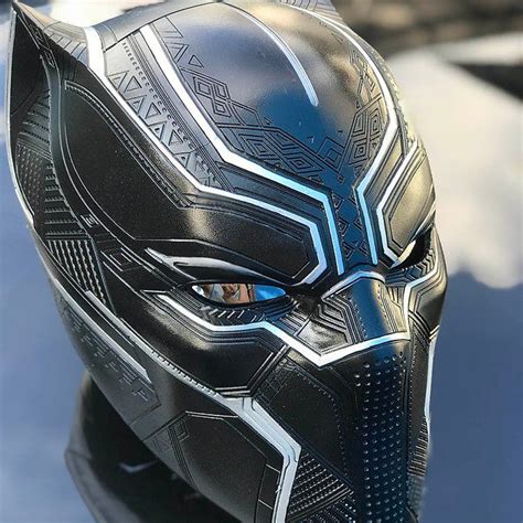 A Close Up Of A Black Panther Mask On Top Of A Car Window Sill