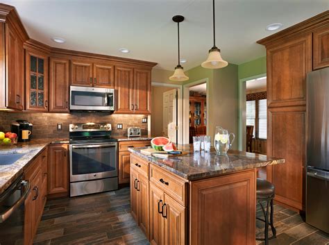 Light brown kitchen cabinets and white appliances. Quality Cabinets For Kitchen & Bath | Wolf Home Products