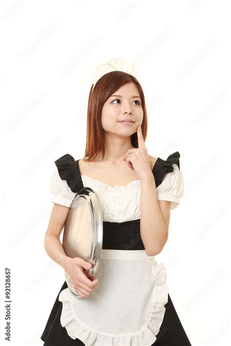 Young Japanese Woman Wearing French Maid Costume Thinks About Something