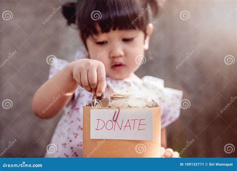 Child With Donation Concept 2 Years Old Child Putting Money Coin Into