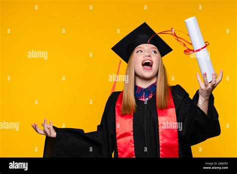 Graduate With Graduation Hat And Diploma On Yellow Background Blonde