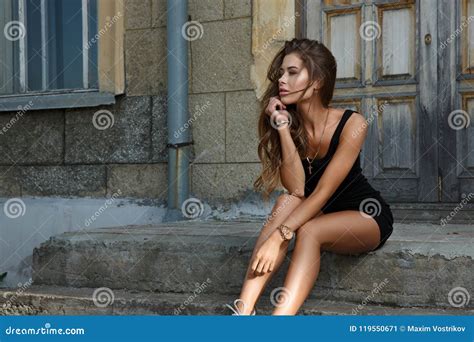 Young Beautiful And Girl With Slim Sun Tanned Attractive Body Dressed In A Slinky Black Singlet