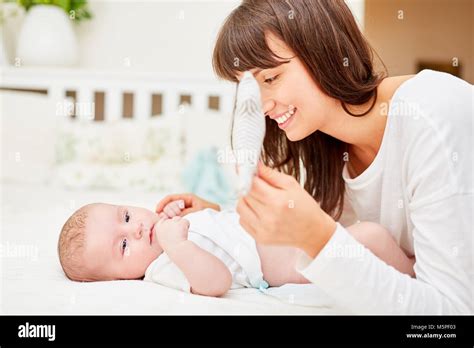 Mother Changing Diapers With Her Newborn Baby Stock Photo Alamy