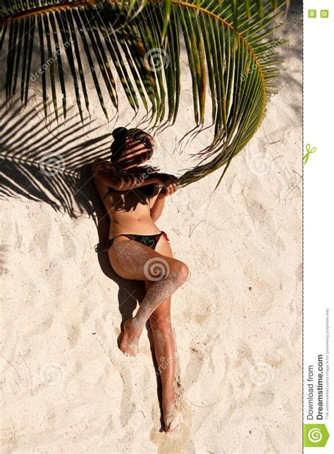 Girl Lying On The Beach And Holding A Palm Branch Stock Image Image