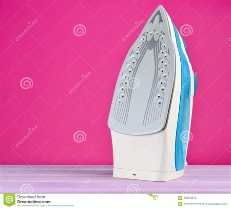 Iron For Ironing On A Colored Pastel Background Minimalist Trend