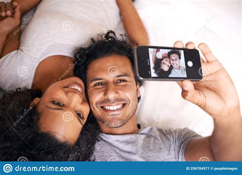 Capturing The Moment A Cute Couple Taking A Selfie On The Bed Stock Image Image Of Casual
