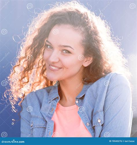Smiling And Happy Young Woman Look At One Side With Curly Hair Stock