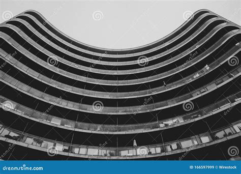 Greyscale Low Angle Shot Of A Modern Building With A Round Facade Stock