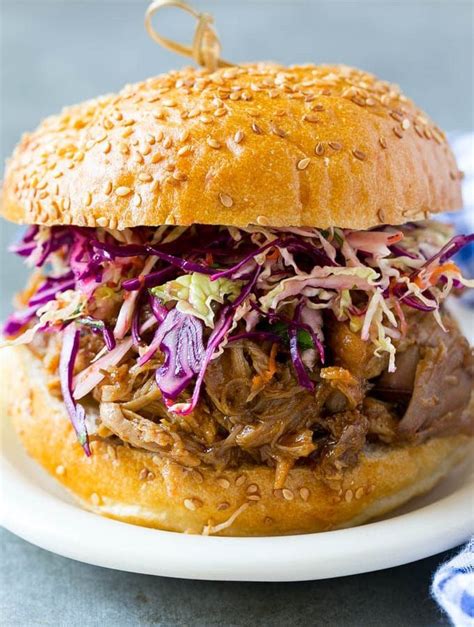 A Pulled Pork Sandwich Topped With Slaw Pulled Pork Recipe Slow
